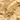 OMID Gold necklace with starfish, shell, and pearl charms on a sandy Background